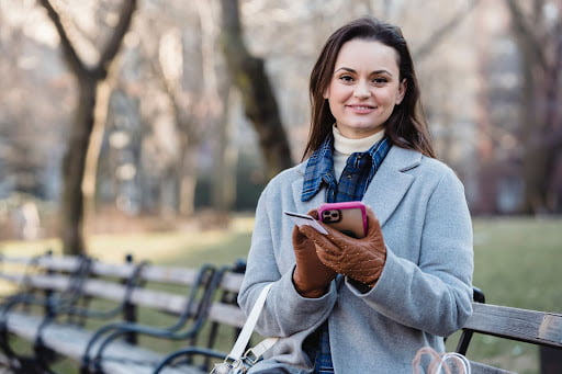 lady smiling and using phone